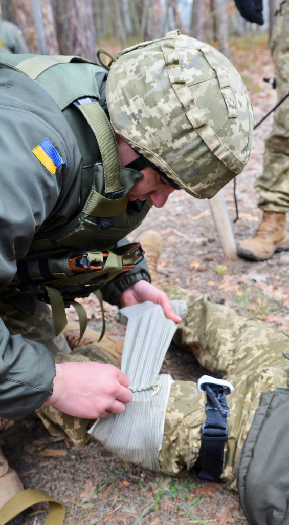 A trainee applies a bandage during training (photo courtesy of US Army)