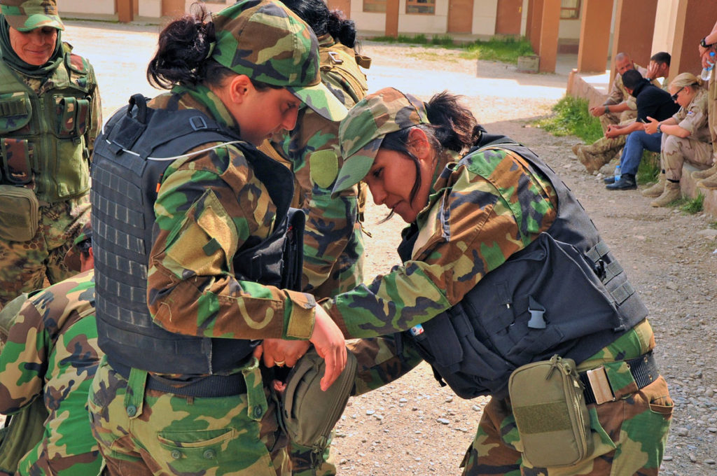 Peshmerga fighters helping to attach medical kits that were donated by Spirit of America