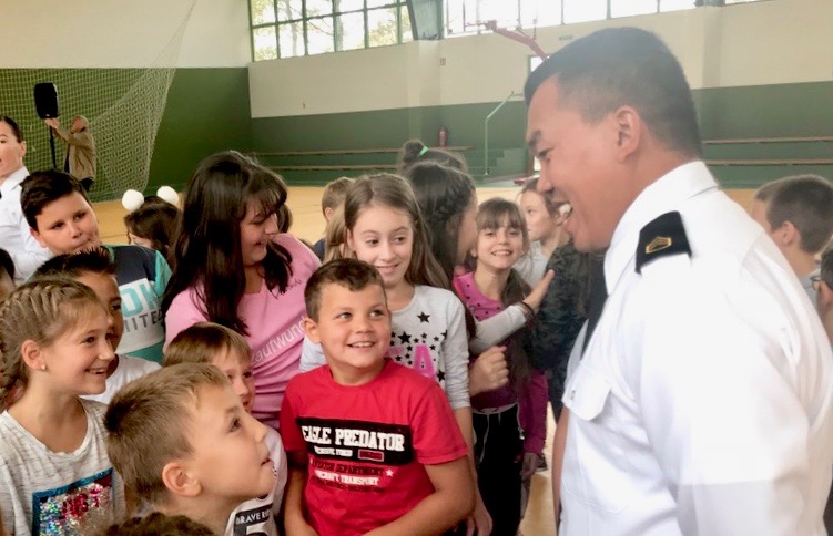 Help US troops and diplomats improve US-Serbian relationships to promote peace in the Balkans